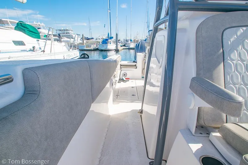 Slide: The Image of 2022 Sea Fox 288 Commander boat interior with gray seating, docked at marina. - 20