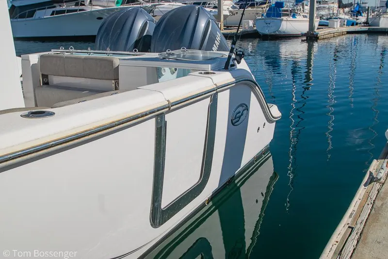 Slide: The Image of 2022 Sea Fox 288 Commander boat docked in marina, featuring dual engines. - 6