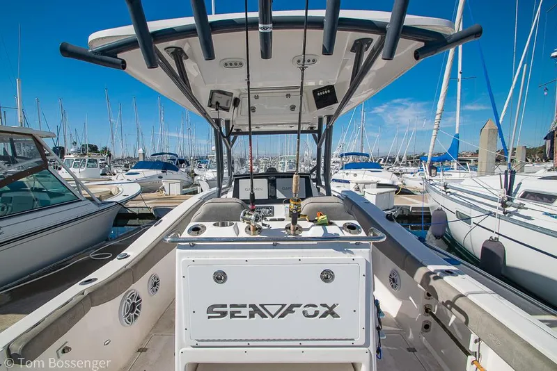 Slide: The Image of 2022 Sea Fox 288 Commander boat docked at a marina, surrounded by sailboats. - 7