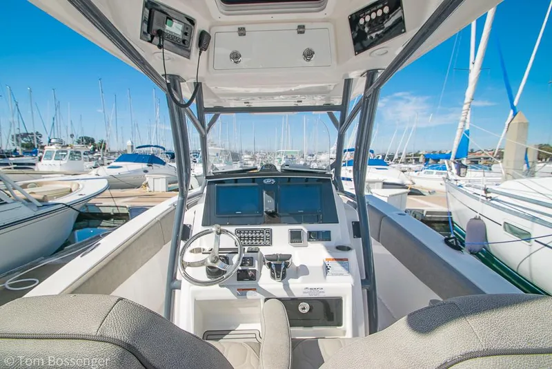 Slide: The Image of 2022 Sea Fox 288 Commander boat cockpit with advanced navigation system, docked at marina. - 9