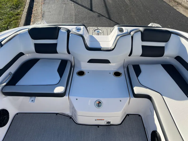 Slide: The Image of 2025 Yamaha Boats SX195 interior seating with sleek design and cup holders. - 18