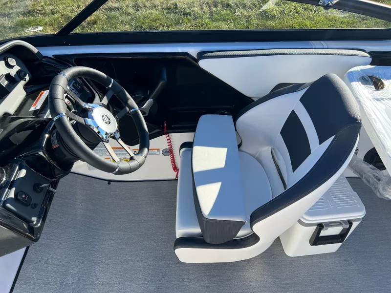 Slide: The Image of 2025 Yamaha Boats SX195 interior with steering wheel and captain's seat. - 21