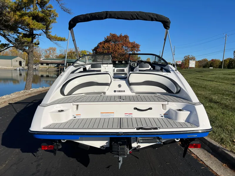 Slide: The Image of 2025 Yamaha Boats SX195, rear view, docked on a sunny day. - 6