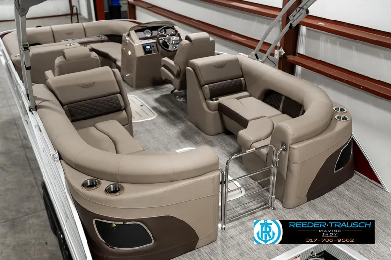 Slide: The Image of 2025 Bennington 25 LTFB pontoon boat interior with luxurious seating and modern dashboard. - 12