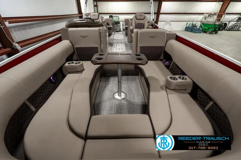 Slide: The Image of 2025 Bennington 25 LTFB pontoon boat interior with luxurious seating and table. - 13