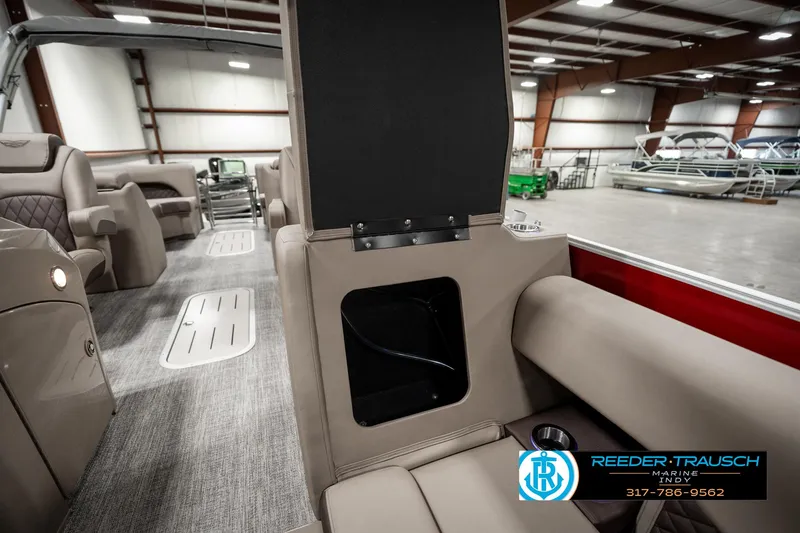Slide: The Image of 2025 Bennington 25 LTFB boat interior with luxurious seating and storage compartment. - 21