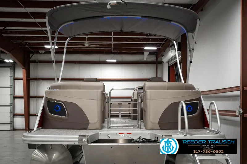 Slide: The Image of 2025 Bennington 25 LTFB pontoon boat in a warehouse setting. - 7