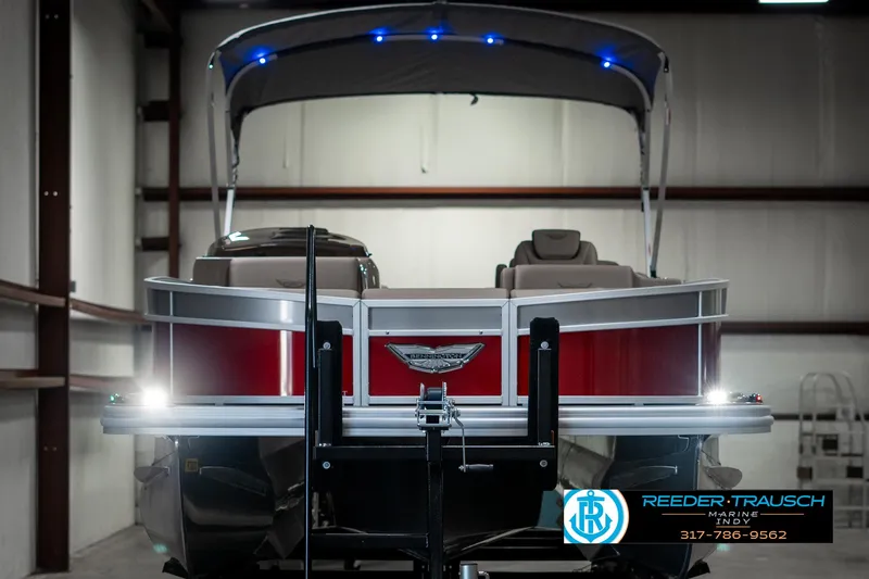 Slide: The Image of 2025 Bennington 25 LTFB pontoon boat in showroom with canopy and lights. - 8