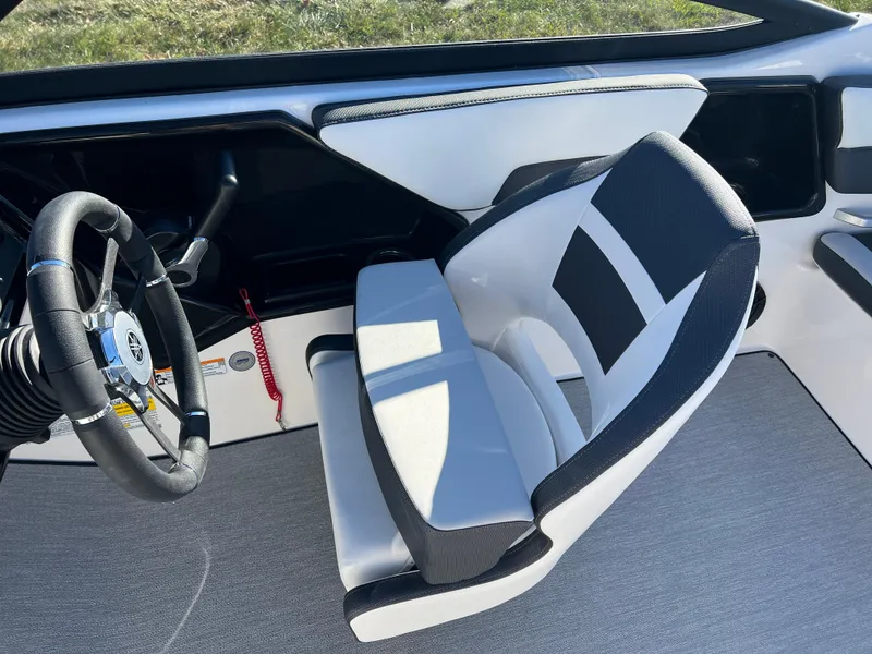 Slide: The Image of 2025 Yamaha SX195 boat interior with steering wheel and cushioned seat. - 21