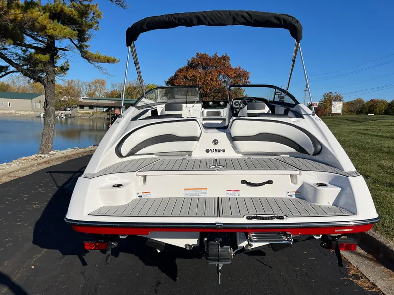 Slide: The Image of 2025 Yamaha Boats SX195, sleek design, docked by a scenic lakeside. - 6
