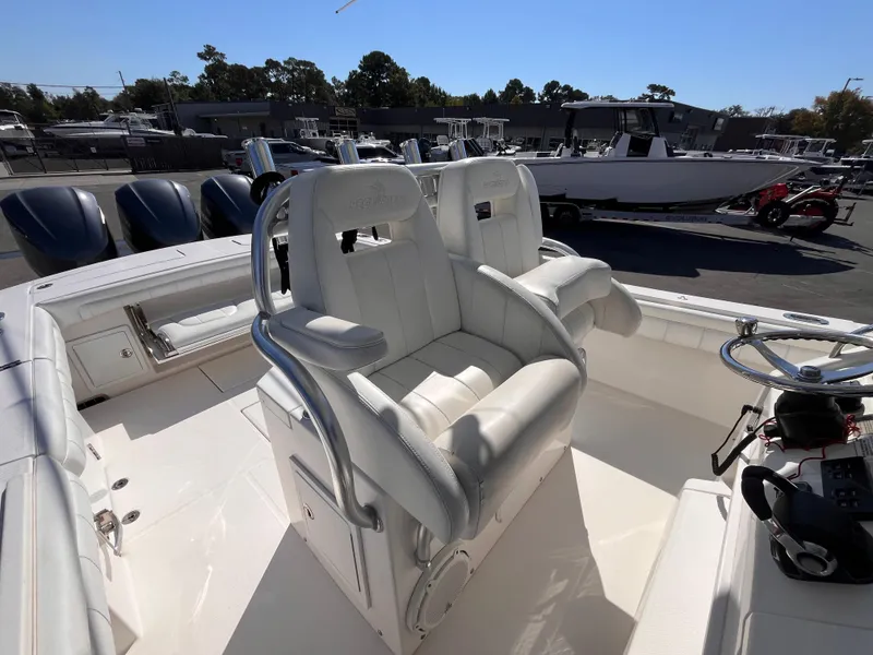 Slide: The Image of 2018 Regulator 34 boat with white seating and multiple outboard engines. - 12