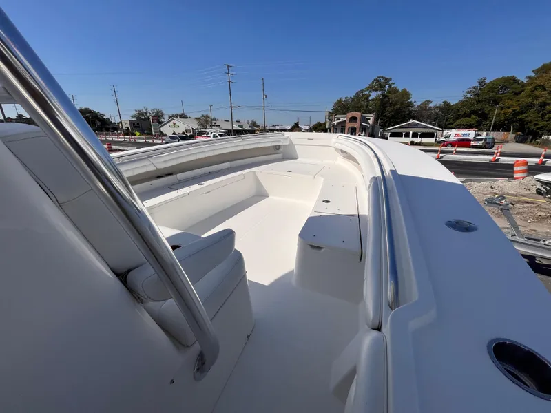 Slide: The Image of 2018 Regulator 34 boat deck with seating, under clear blue sky. - 14