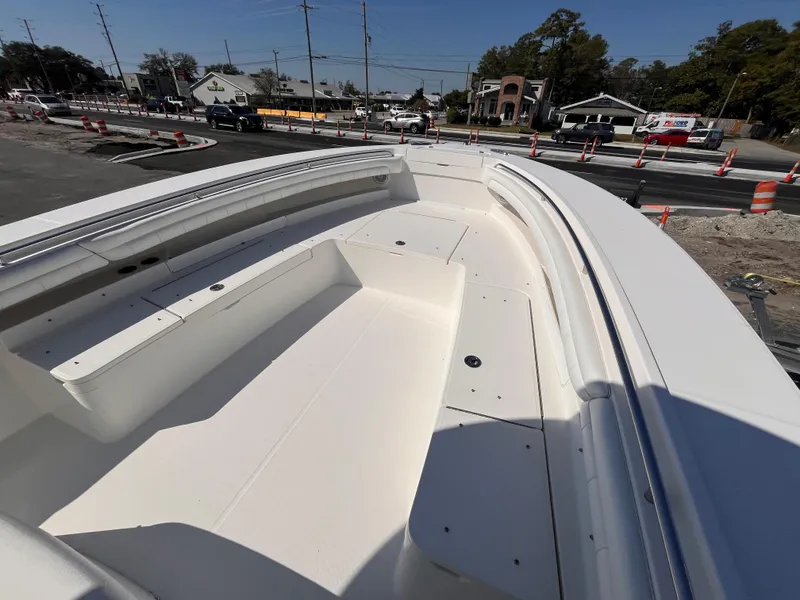 Slide: The Image of 2018 Regulator 34 boat deck with seating, parked near construction area. - 15
