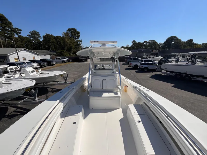 Slide: The Image of 2018 Regulator 34 boat, white interior, parked in a marina with other boats. - 16