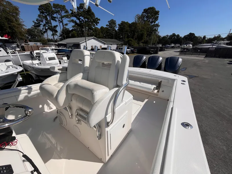 Slide: The Image of 2018 Regulator 34 boat with dual helm seats and triple outboard engines. - 19