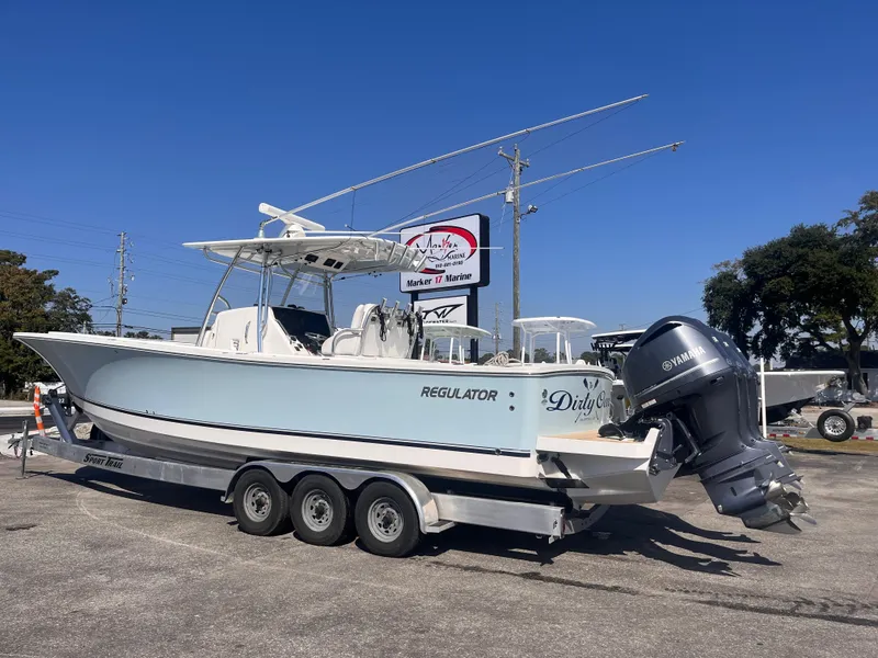 Slide: The Image of 2018 Regulator 34 boat on trailer with Yamaha outboard, parked outdoors. - 2
