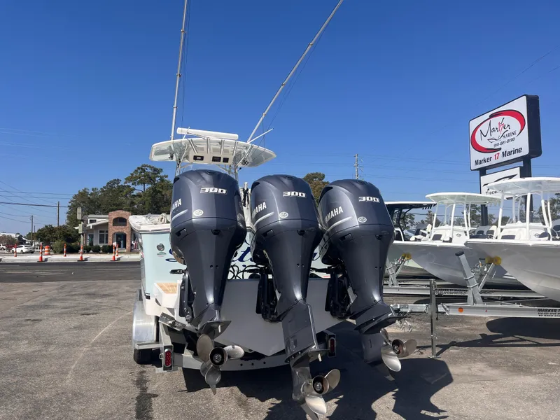Slide: The Image of 2018 Regulator 34 boat with triple Yamaha 300 engines at a marina. - 3