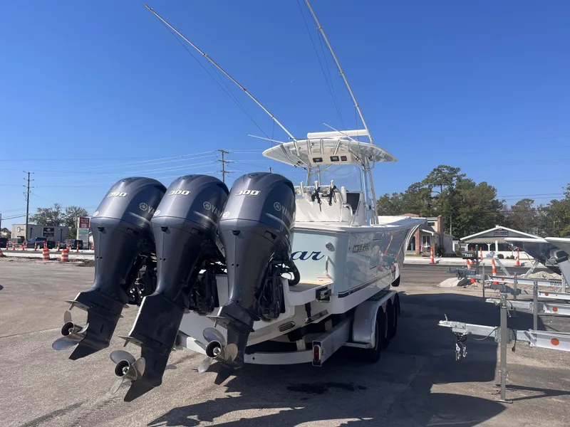 Slide: The Image of 2018 Regulator 34 boat with triple outboard engines on a trailer. - 4
