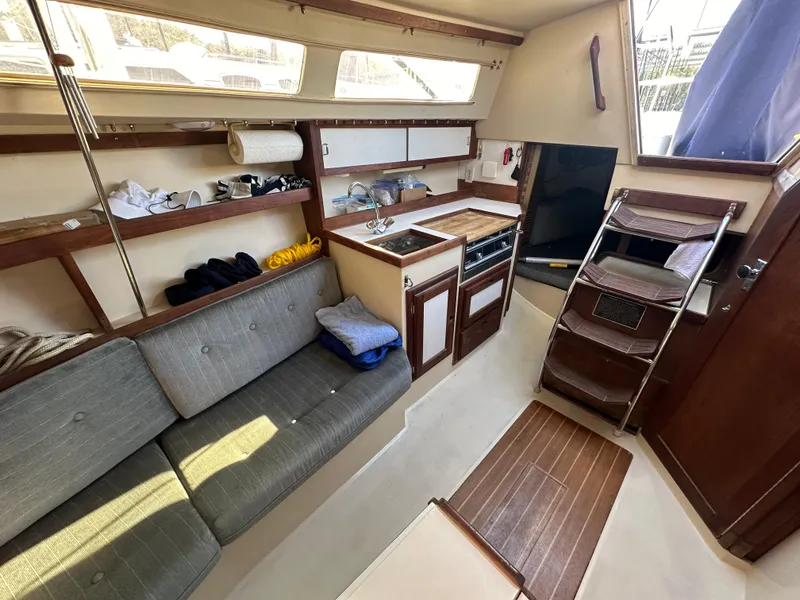 Slide: The Image of Interior of 1991 Catalina 28 sailboat with cozy seating and compact kitchen area. - 20