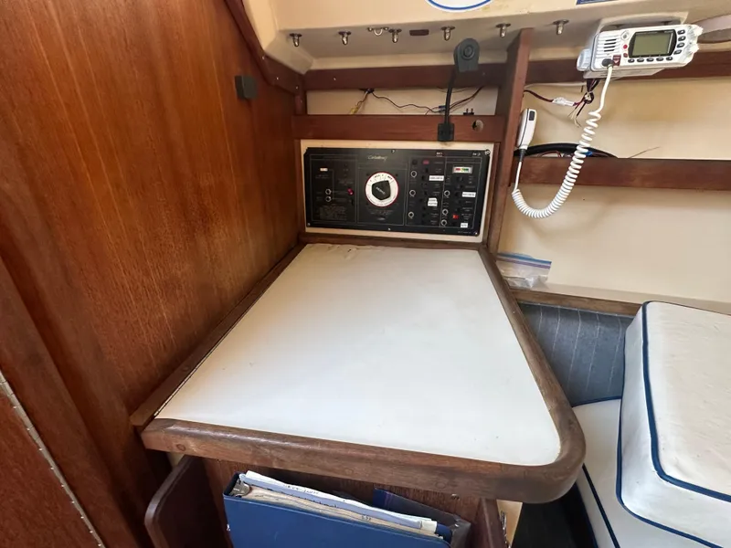 Slide: The Image of Navigation station inside 1991 Catalina 28 sailboat with control panel and radio equipment. - 24