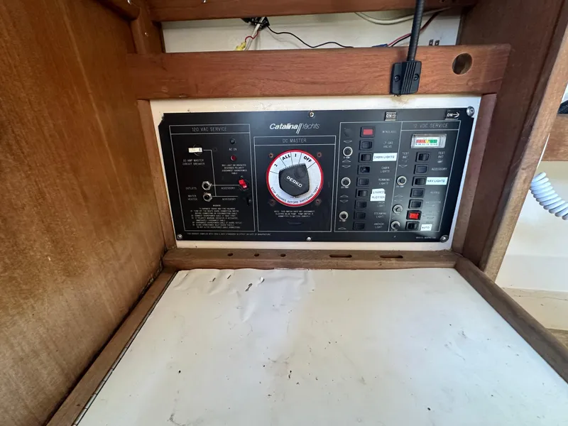 Slide: The Image of Control panel of a 1991 Catalina 28 sailboat, featuring various switches and dials. - 26