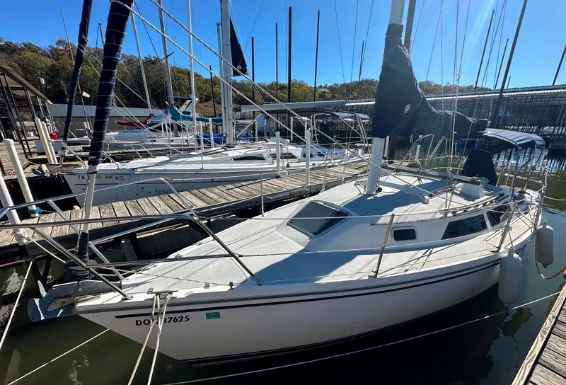 Slide: The Image of 1991 Catalina 28 sailboat docked at marina under clear blue sky. - 5