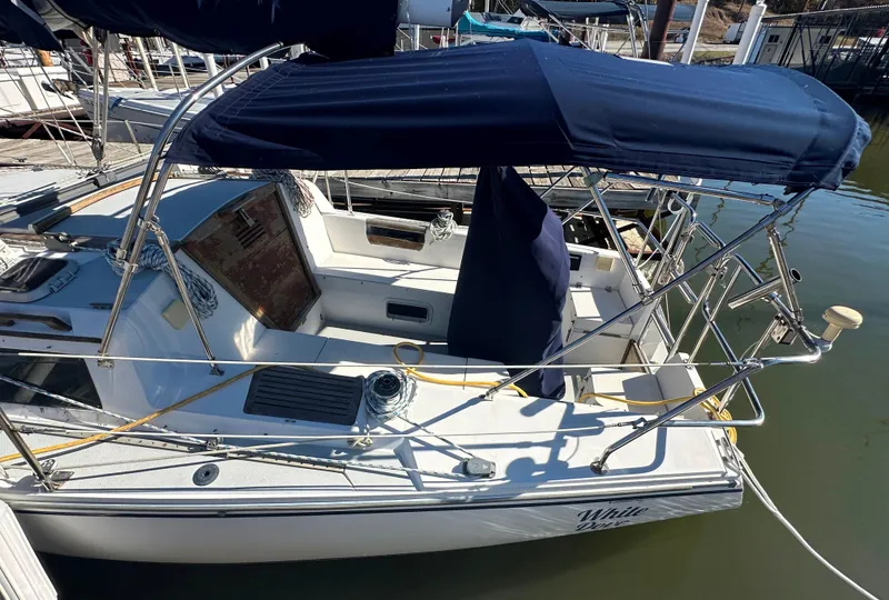 Slide: The Image of 1991 Catalina 28 sailboat with blue canopy docked at marina. - 7