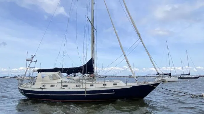 The Image of 1993 Pacific Seacraft 44 Voyager sailboat on calm waters under a blue sky. - 0
