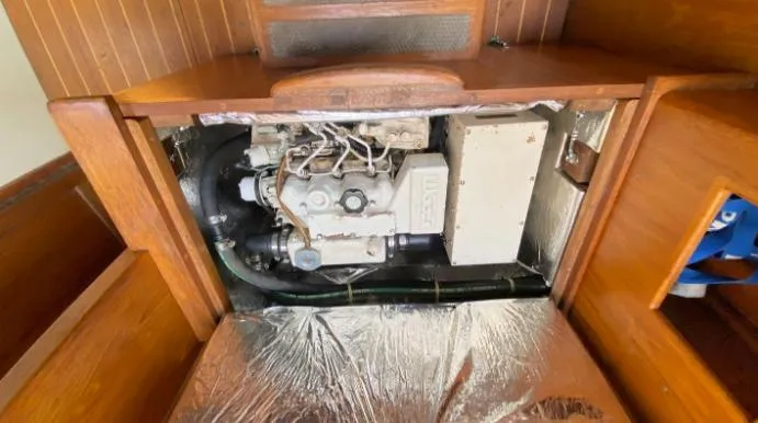Slide: The Image of Engine compartment of 1993 Pacific Seacraft 44 Voyager sailboat, showcasing mechanical components. - 13