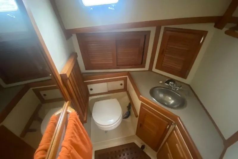 Slide: The Image of Bathroom interior of 1993 Pacific Seacraft 44 Voyager yacht with wooden accents and stainless steel sink. - 16