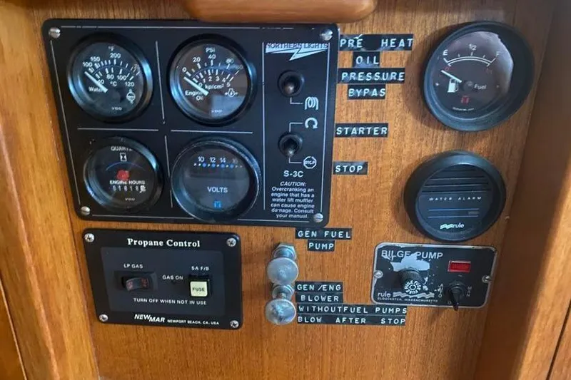 Slide: The Image of Control panel of a 1993 Pacific Seacraft 44 Voyager sailboat with gauges and switches. - 17