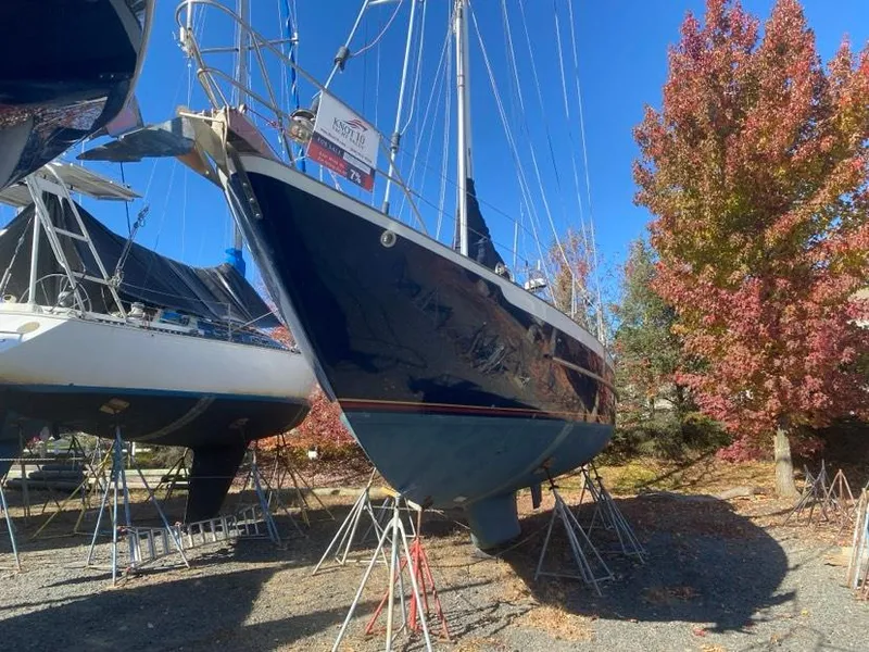 Slide: The Image of Sailboat on stands, 1993 Pacific Seacraft 44 Voyager, autumn trees in background. - 2