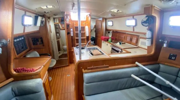 Slide: The Image of Interior of 1993 Pacific Seacraft 44 Voyager sailboat, featuring wood paneling and seating. - 4