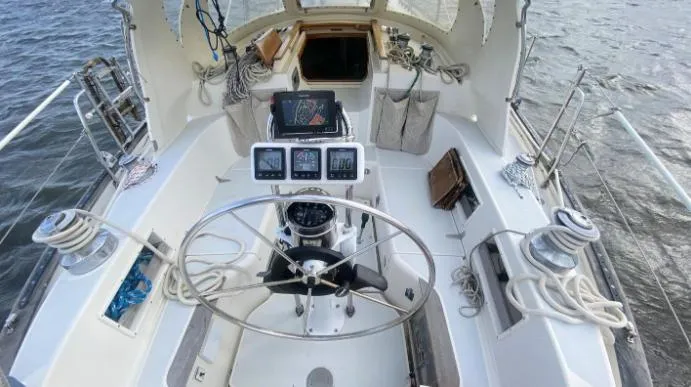 Slide: The Image of Cockpit of 1993 Pacific Seacraft 44 Voyager sailboat with steering wheel and navigation instruments. - 5