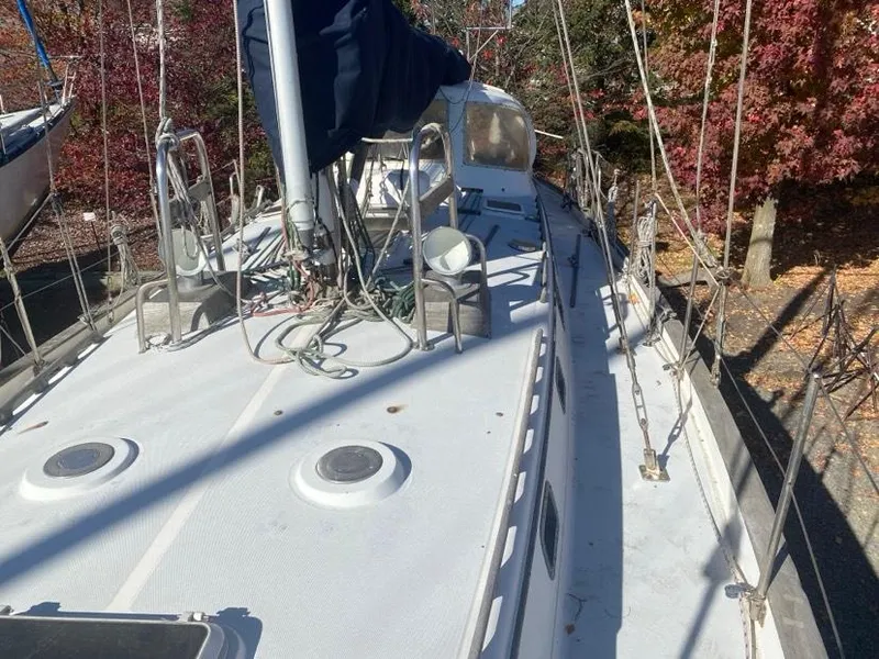 Slide: The Image of 1993 Pacific Seacraft 44 Voyager sailboat deck with rigging and autumn foliage background. - 7