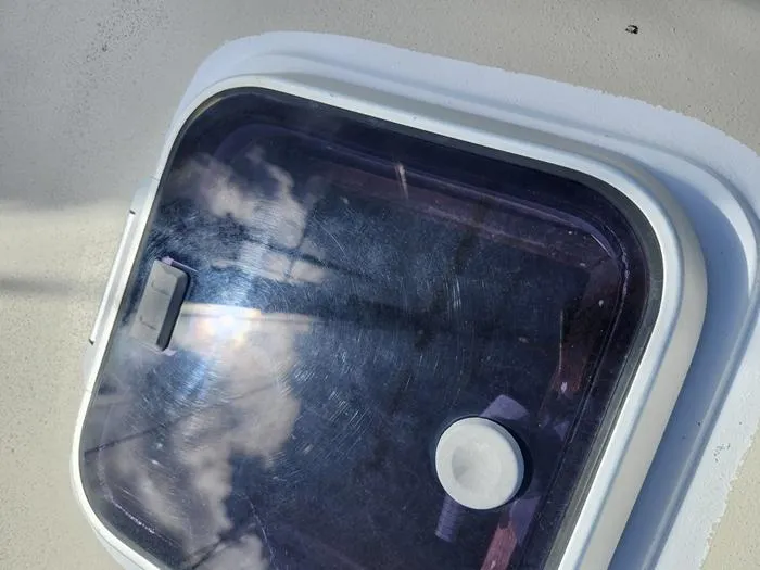 Slide: The Image of Hatch window on 1983 Morgan Schooner reflecting sky and clouds. - 11