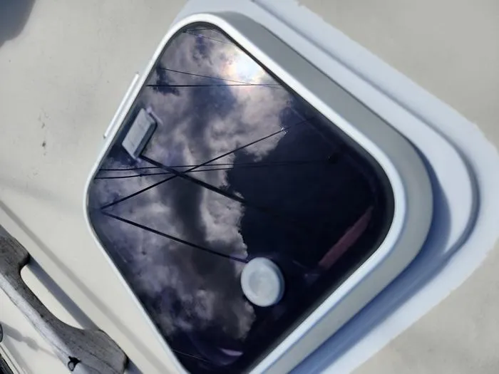 Slide: The Image of 1983 Morgan Schooner hatch reflecting sky and rigging. - 12