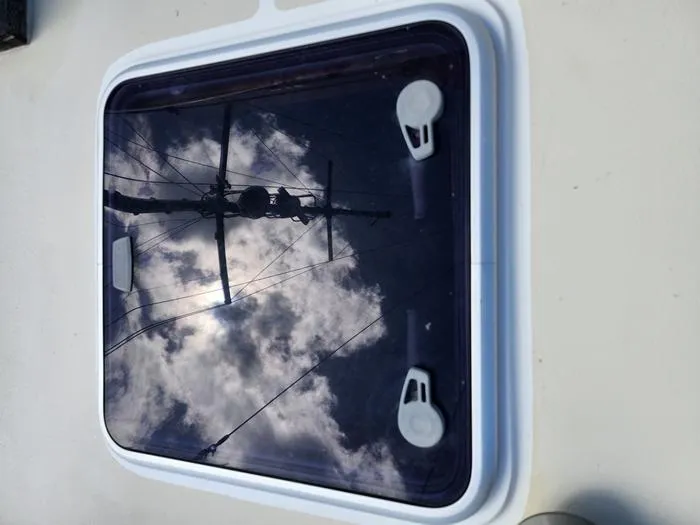 Slide: The Image of Reflection of a schooner's mast and clouds on a hatch window, Morgan Schooner 1983. - 15