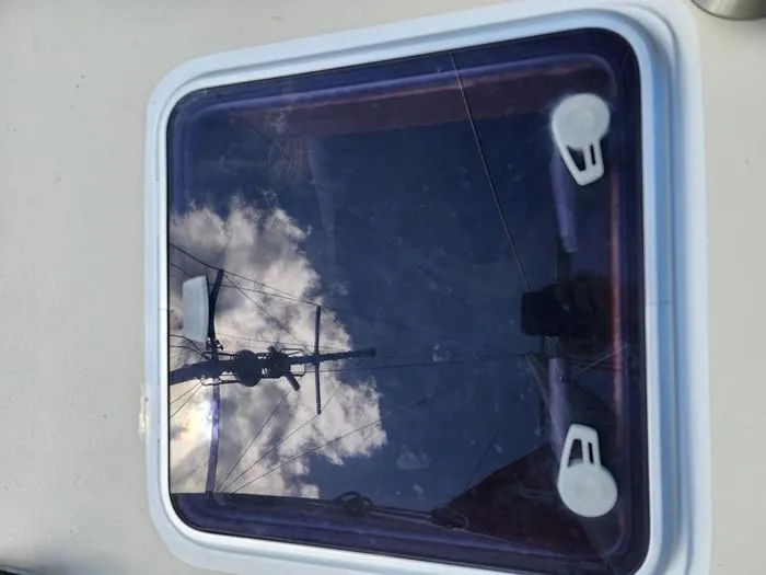 Slide: The Image of Reflection of sky and mast on 1983 Morgan Schooner hatch window. - 16