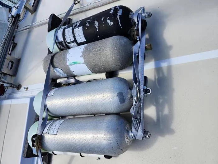 Slide: The Image of Four secured scuba tanks on a 1983 Morgan Schooner deck. - 17