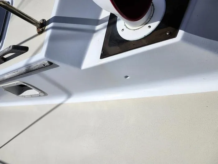 Slide: The Image of Close-up of 1983 Morgan Schooner deck details, featuring metal fittings and a white surface. - 20