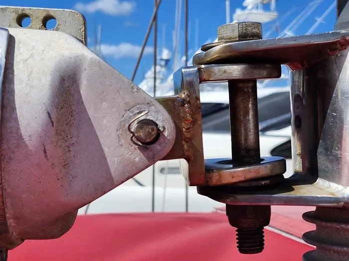 Slide: The Image of Close-up of a 1983 Morgan Schooner's metal rigging against a marina backdrop. - 25