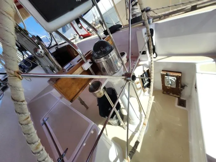 Slide: The Image of 1983 Morgan Schooner cockpit with navigation equipment and steering wheel. - 29