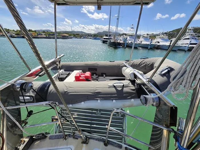 Slide: The Image of 1983 Morgan Schooner with inflatable dinghy docked in a sunny marina. - 31