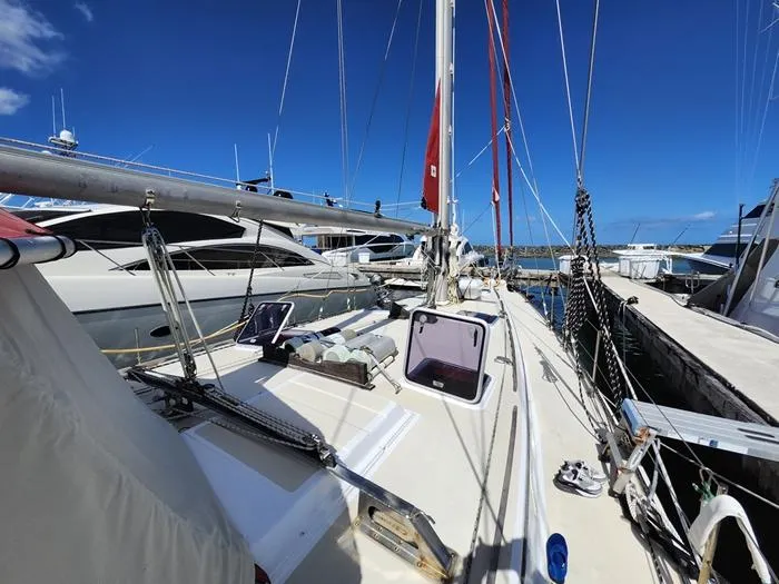 Slide: The Image of 1983 Morgan Schooner docked at marina under clear blue sky. - 37