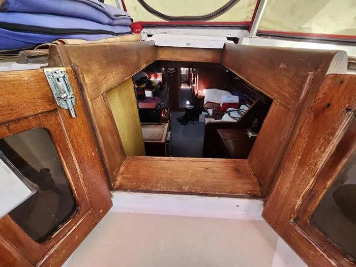 Slide: The Image of Interior view of a 1983 Morgan Schooner sailboat with wooden cabinetry. - 43