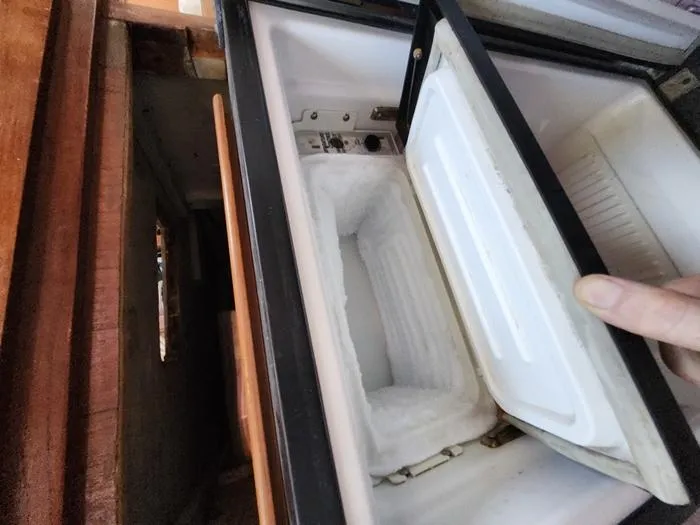 Slide: The Image of 1983 Morgan Schooner freezer compartment with open lid, showing interior storage space. - 45