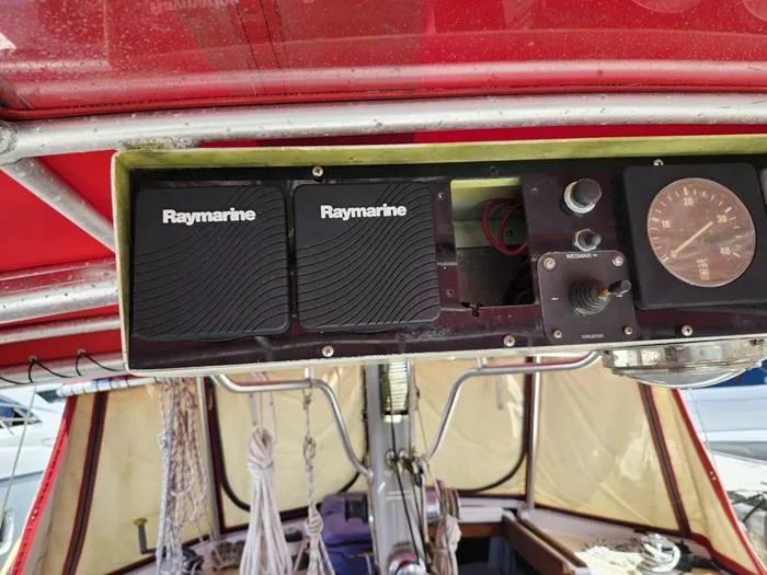 Slide: The Image of 1983 Morgan Schooner cockpit with Raymarine navigation equipment and gauges. - 7