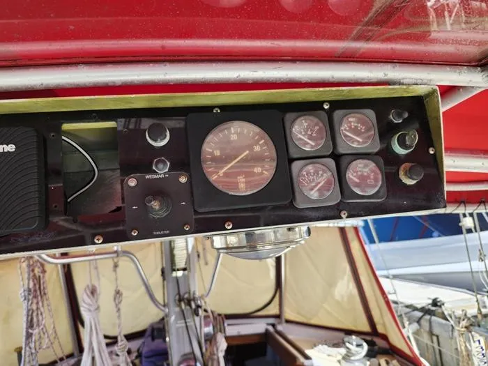 Slide: The Image of 1983 Morgan Schooner dashboard with gauges and controls under a red canopy. - 8