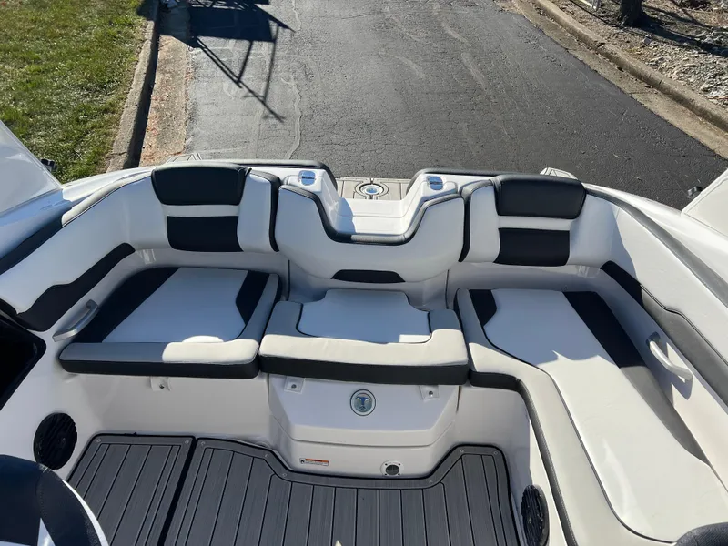 Slide: The Image of 2025 Yamaha Boats 195S interior seating, featuring sleek black and white upholstery. - 18